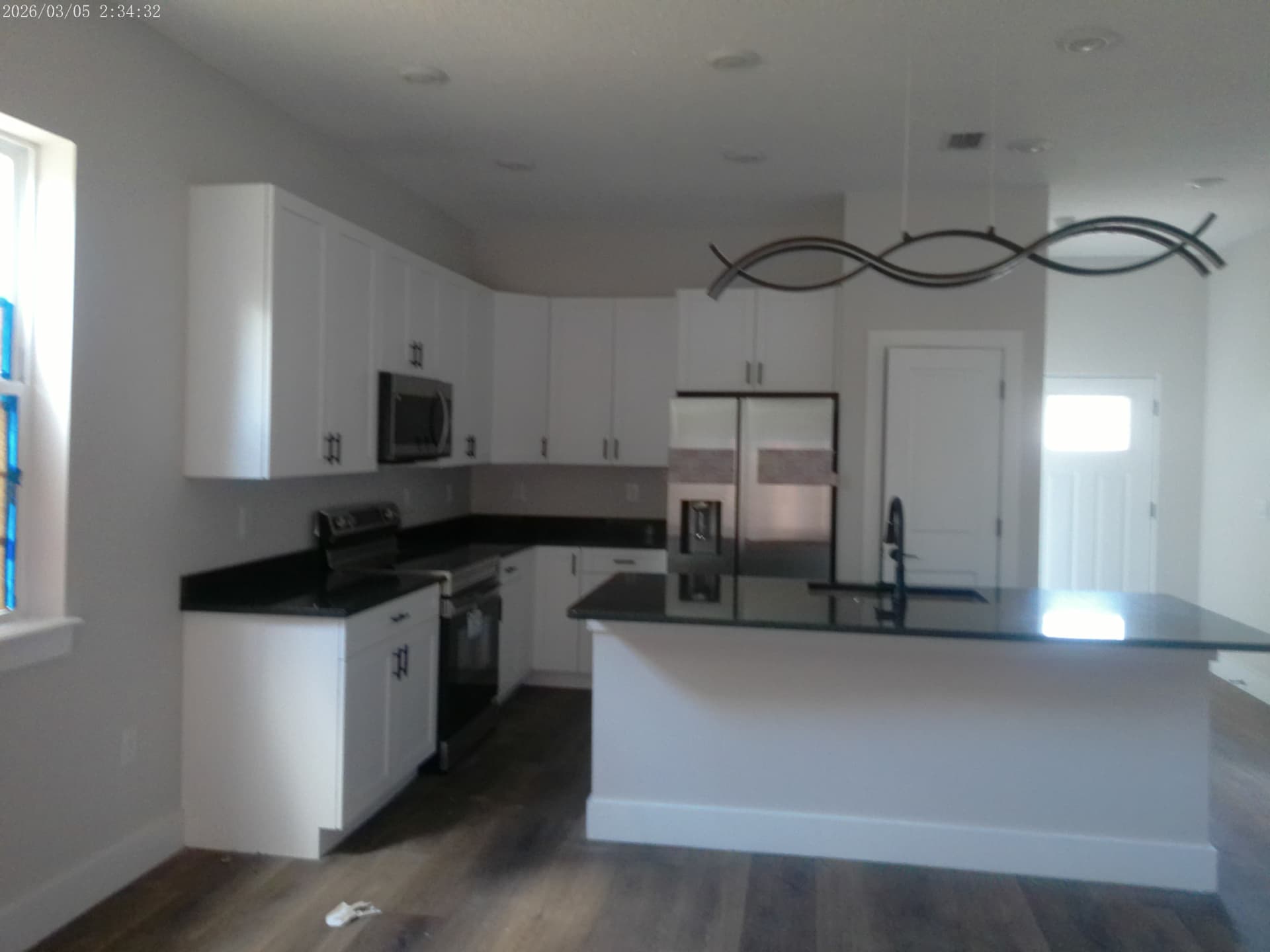 Open kitchen at 1436 Florida Avenue with white shaker cabinets, granite counters, and stainless appliances