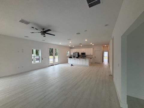 Open-concept living space with natural light from rear glass doors