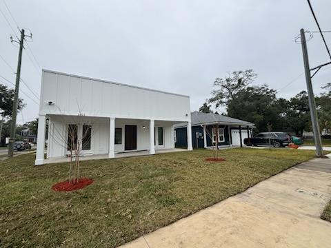 Front elevation of the completed modern home at 1402 Florida Avenue with covered porch and new sod