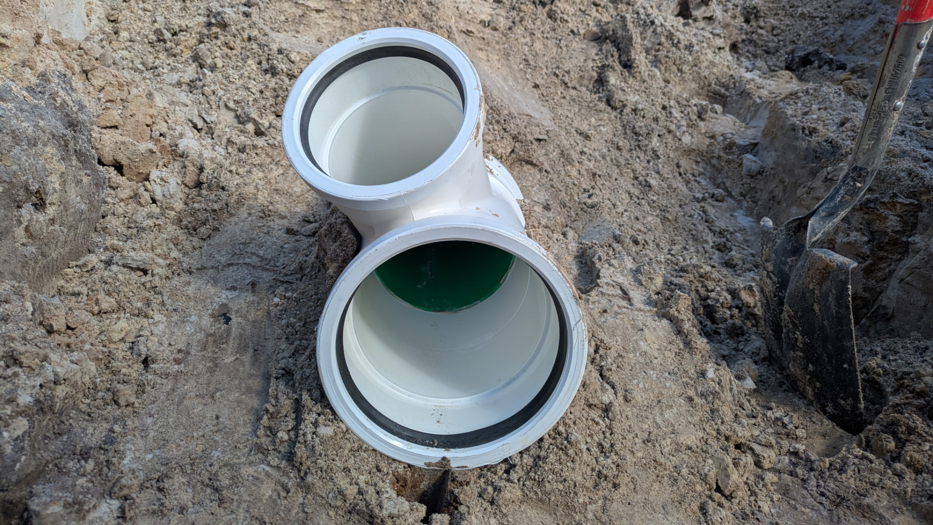New PVC service wye fitting set in place for a sewer service tie-in