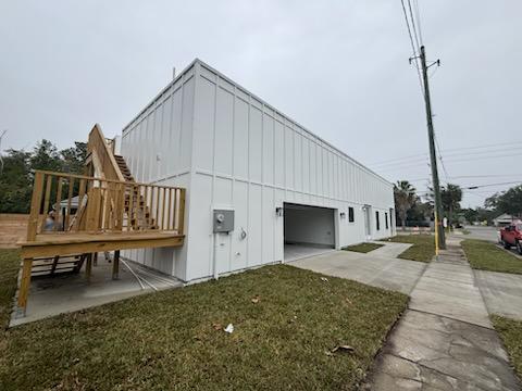 Rear of the Florida Avenue home with attached garage and new deck framing