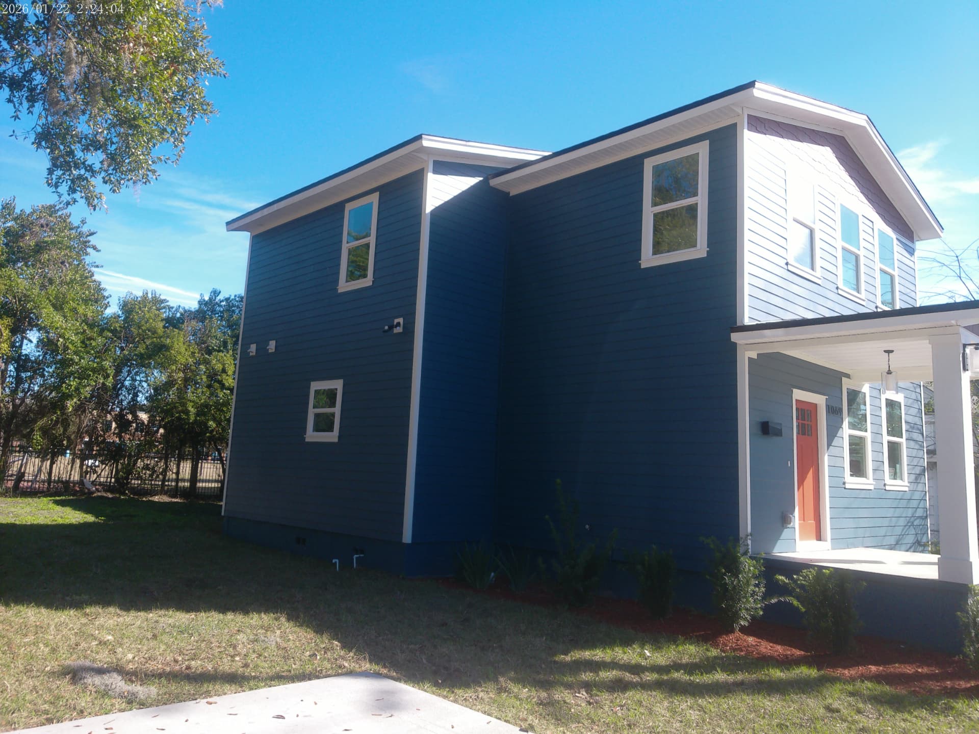 Completed Spearing Street home from the side showing two-tone fiber cement siding