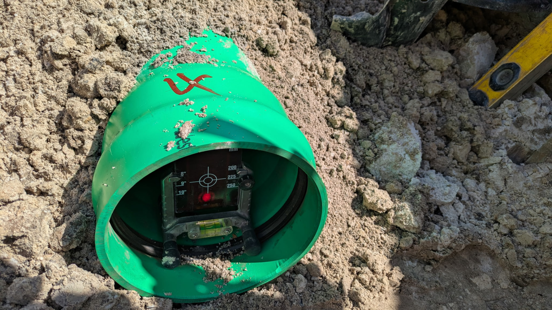 Laser grade target set inside a green gravity sewer pipe