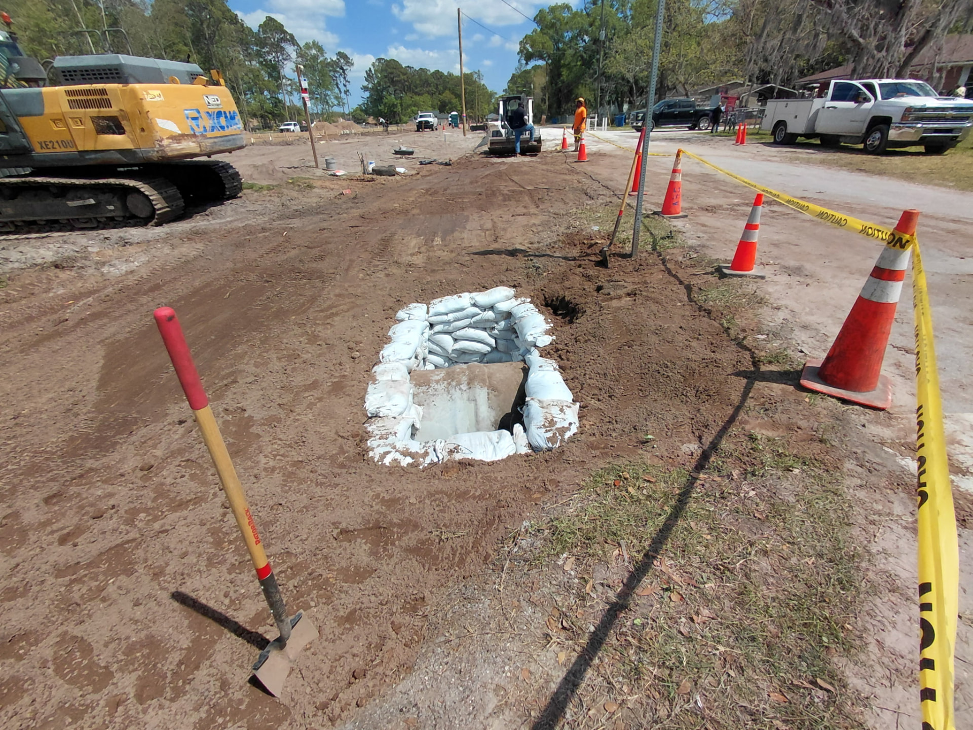 Drainage structure protected with sandbag inlet protection in the roadway work zone